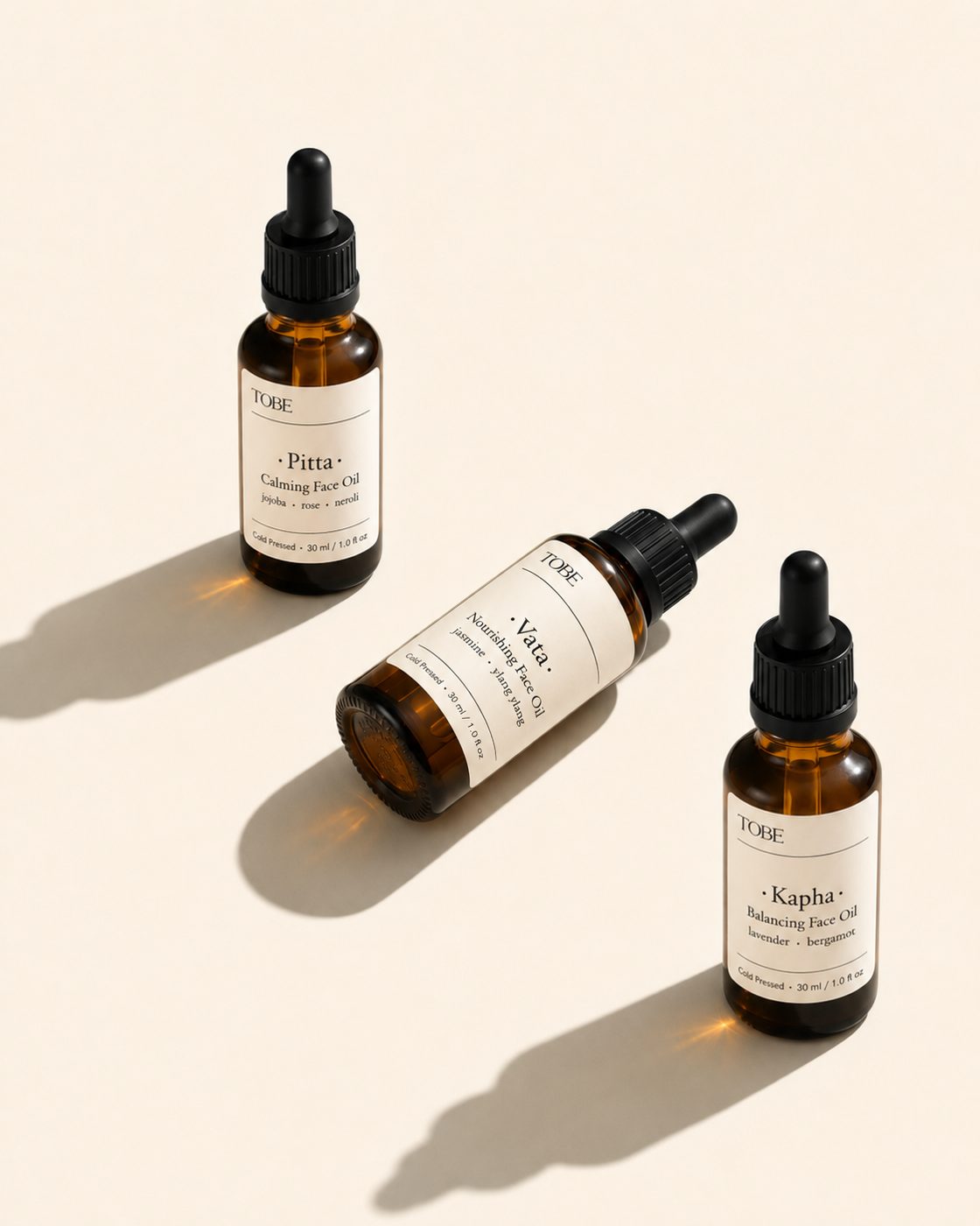 Pitta, Vata and Kapha bottles on cream