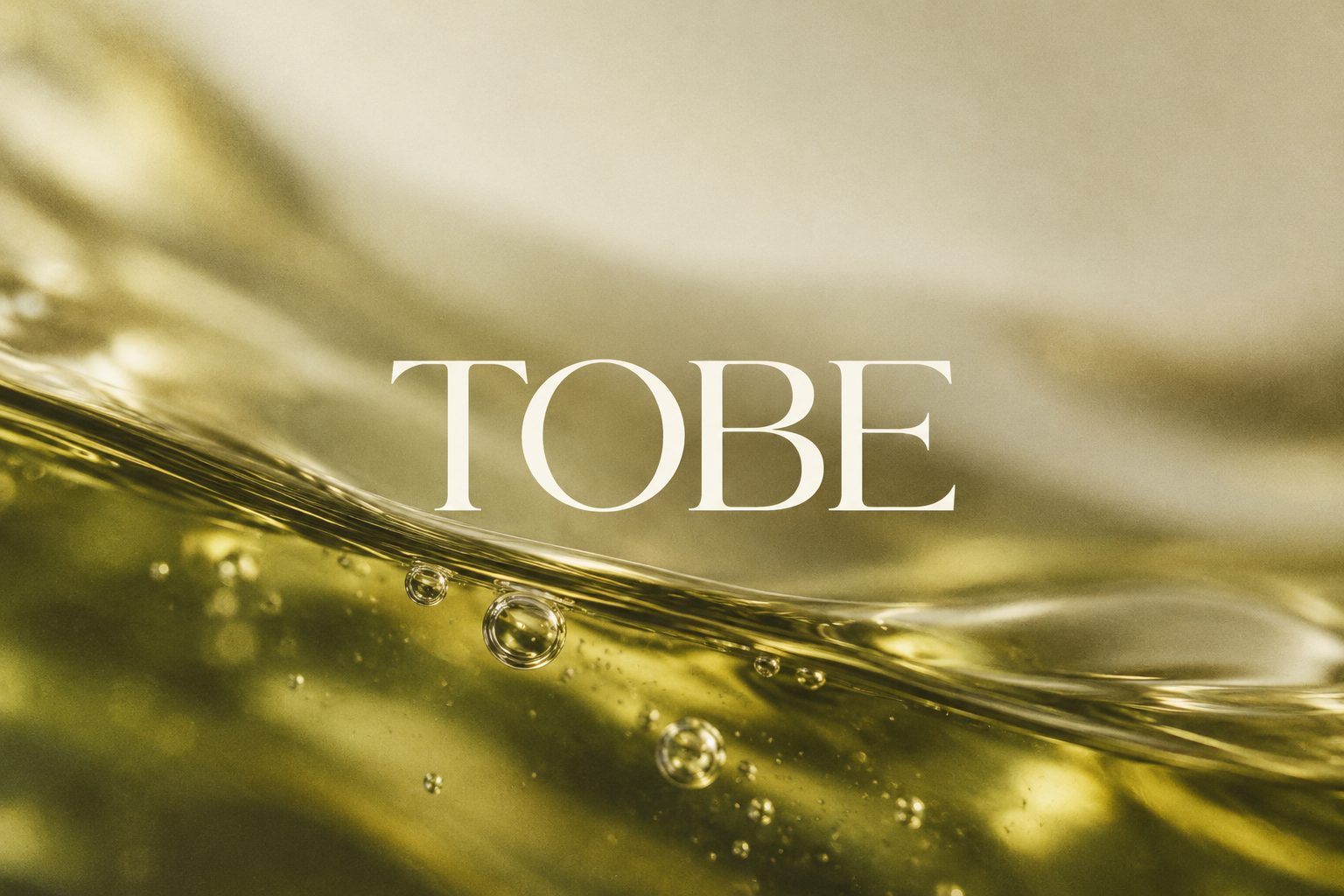 TOBE wordmark over golden face oil
